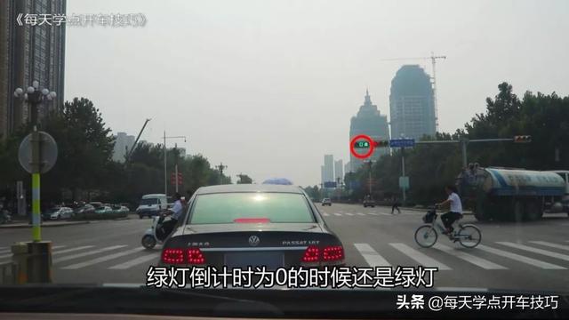 路口绿灯时前轮过线后，突然绿灯变红灯，到底能不能继续走？