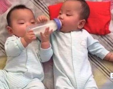 妈妈在厨房做事，双胞胎儿子放床上，进屋时瞬间眼睛眯成一条线