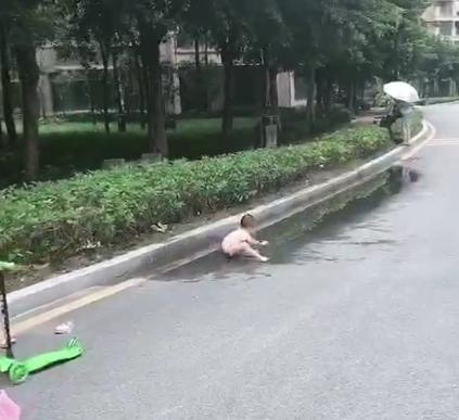 孩子路边玩着泥水，妈妈在一旁玩手机，网友：别人家的妈妈